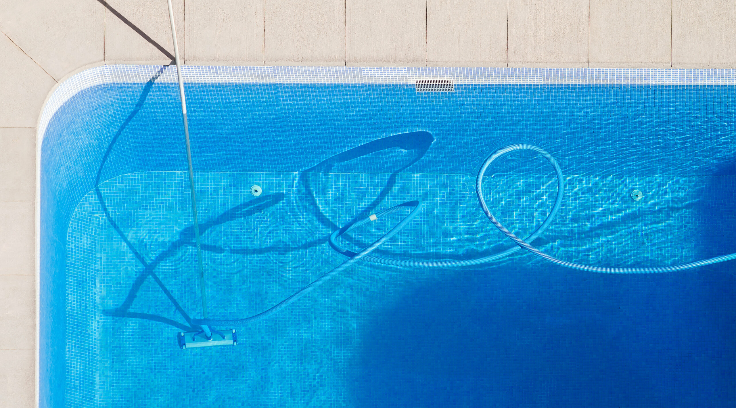 swimming pool cleaning to maintenance by lifeguard worker