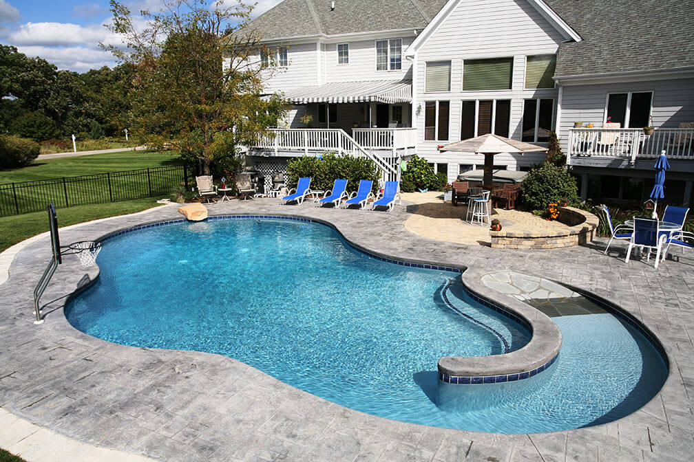 Backyard pool design with entrance and exit ramp