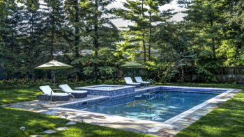 backyard pool area with trees