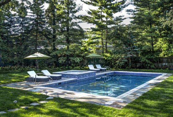 backyard pool area with trees