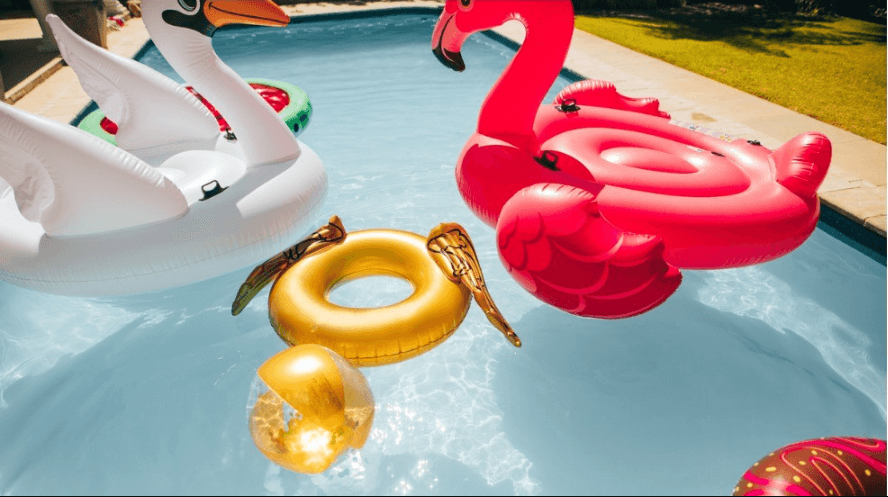 Fun pool floats in a pool on a sunny day