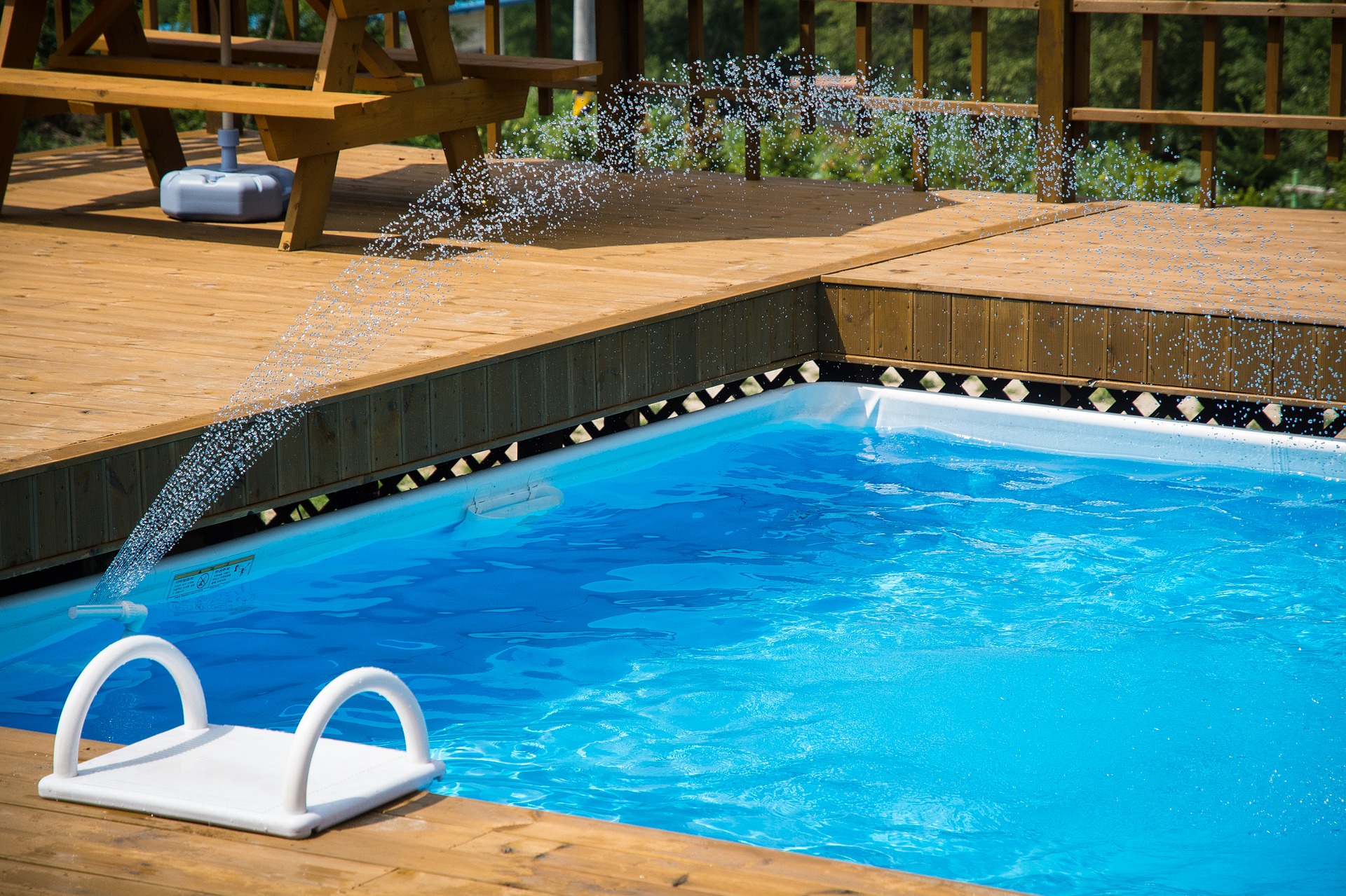 Swimming pool with fountain on a sunny summer day