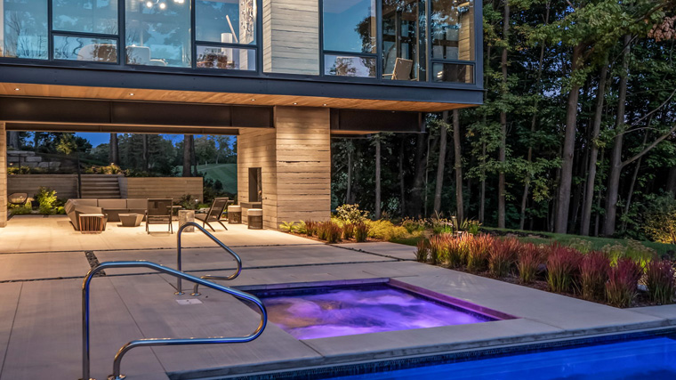 Luxurious custom inground concrete pool with integrated spa by Sunset Pools & Spas.